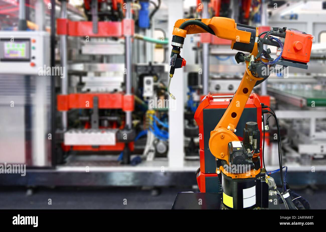Système de machine-outil à main robotique orange en usine, concept de robot industriel . Banque D'Images