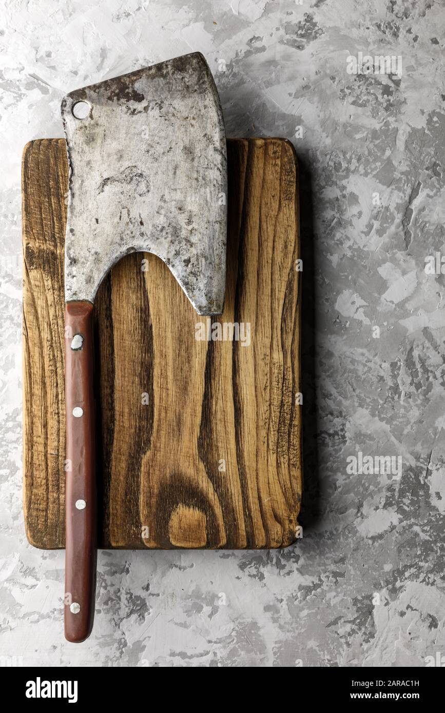 Rustique ancienne ax pour la viande sur une planche en bois sur grunge background. La photographie alimentaire Banque D'Images