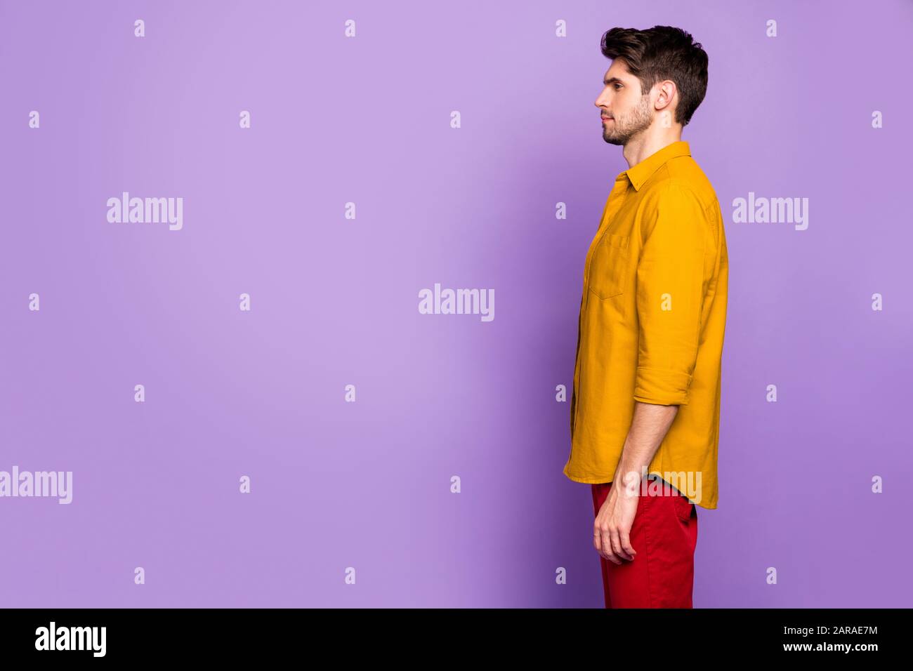 Photo de profil latéral d'un pondeur sérieux confiant contemplant de nouvelles informations dans un espace vide à remplir isolé couleur violet pastel Banque D'Images