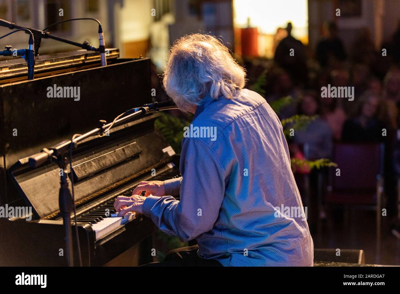 Artiste masculin piano joueur jouant au clavier tout en chantant la chanson  sur le microphone lors de spectacle en direct devant le public Photo Stock  - Alamy