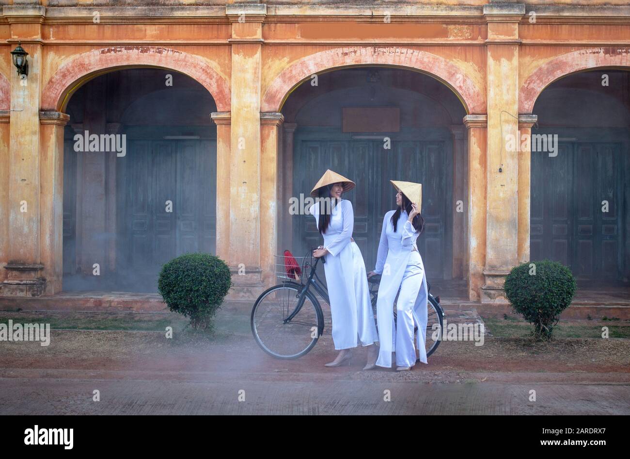 Deux femmes portant la robe traditionnelle Ao Dai Vietnam séjour dans l'ancien village Banque D'Images