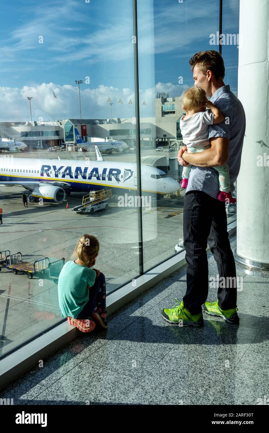 Famille attendant à l'aéroport, homme et enfants regardent les avions sur la piste de l'aéroport Palma de Majorque Ryanair Banque D'Images