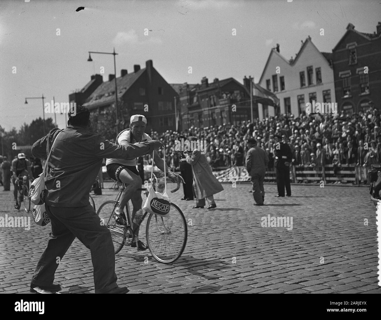 Tour de France, Tour de France cavaliers à Rotterdam, Kees Pellenaars atteint Henk Faanhof sac alimentaire de Date: 8 juillet 1954 lieu: Rotterdam, Zuid-Holland mots clés: Sport, cyclisme Nom personnel: Faanhof Henk, Pellenaars, Kees Banque D'Images