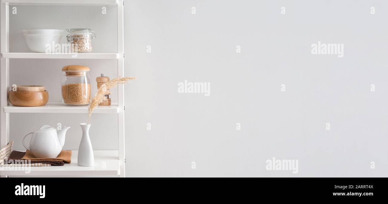 Ustensiles de cuisine sur étagères près du mur blanc avec espace pour le texte Banque D'Images