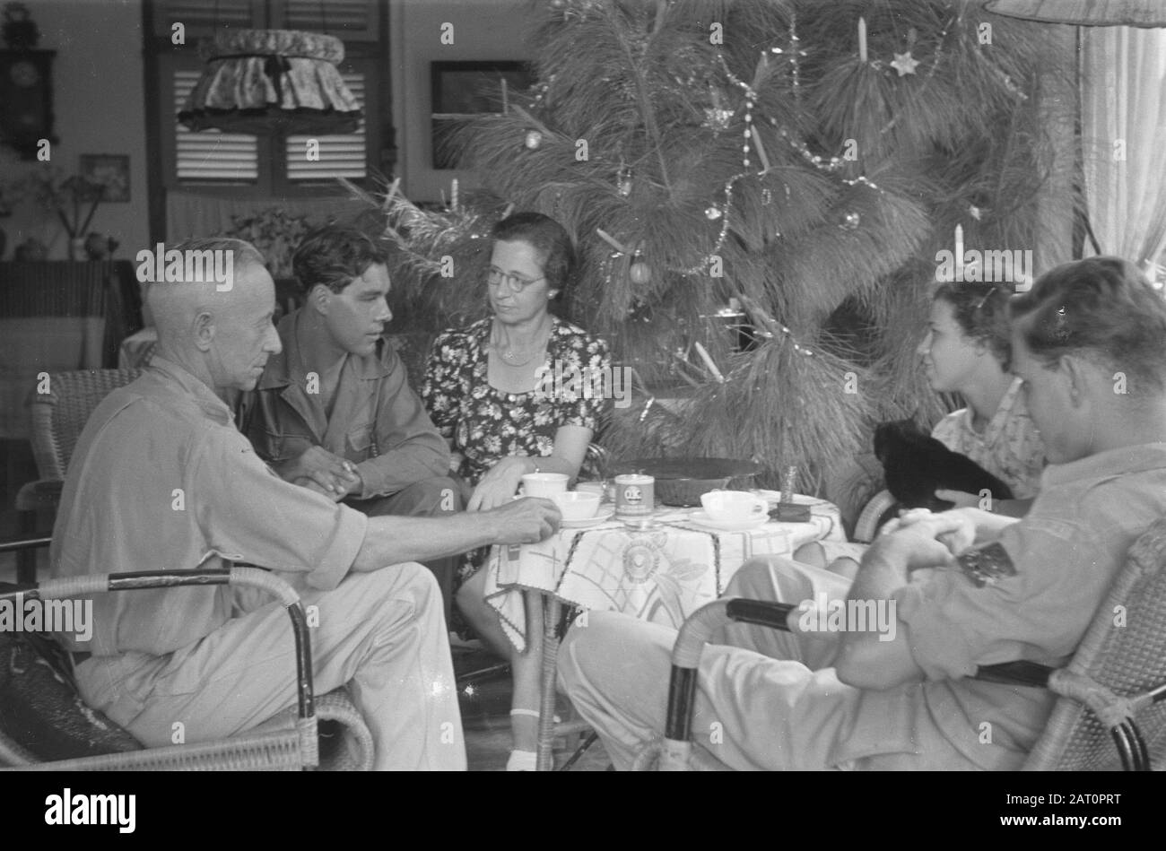 Fleurs pour la célébration des morts et de Noël à Semarang une compagnie autour d'une table près d'un arbre de Noël décoré Date: 25 décembre 1947 lieu: Indonésie, Pays-Bas Indes de l'est Banque D'Images