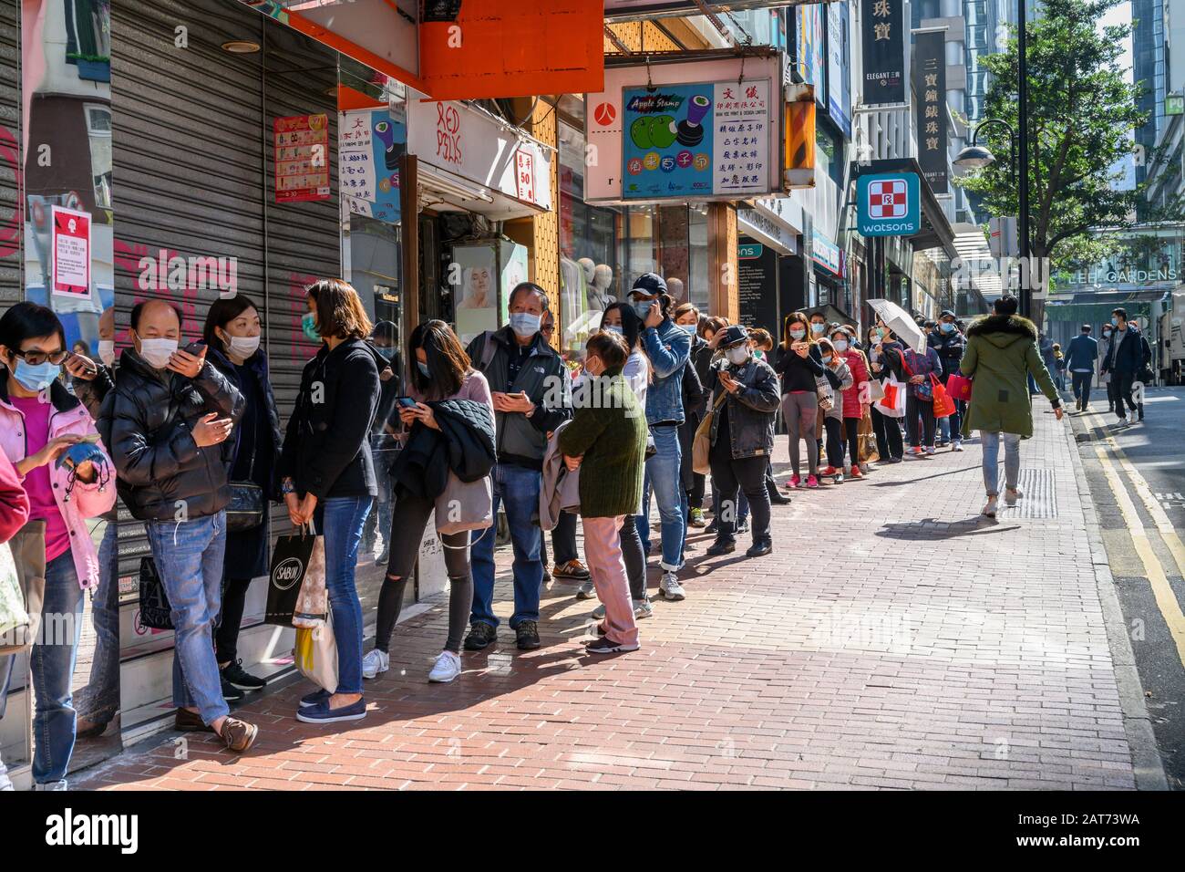 Hong Kong. 31 janvier 2020. Des centaines de personnes font la queue pour acheter des masques chirurgicaux dans les magasins Bonjour Cosmetics de Causeway Bay Hong Kong. Il y a une pénurie de masques de visage dans la ville et les gens se présentent souvent pendant des heures dans l'espoir d'en acheter à des prix gonflés. Banque D'Images