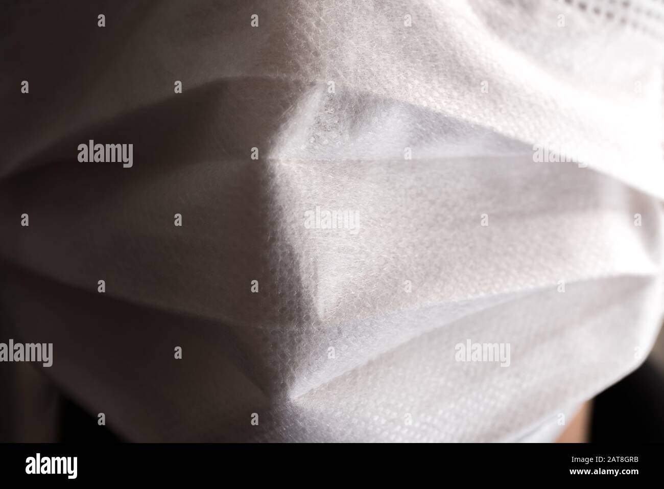 Gros plan sur le visage d'un jeune homme portant un masque médical ou chirurgical Banque D'Images