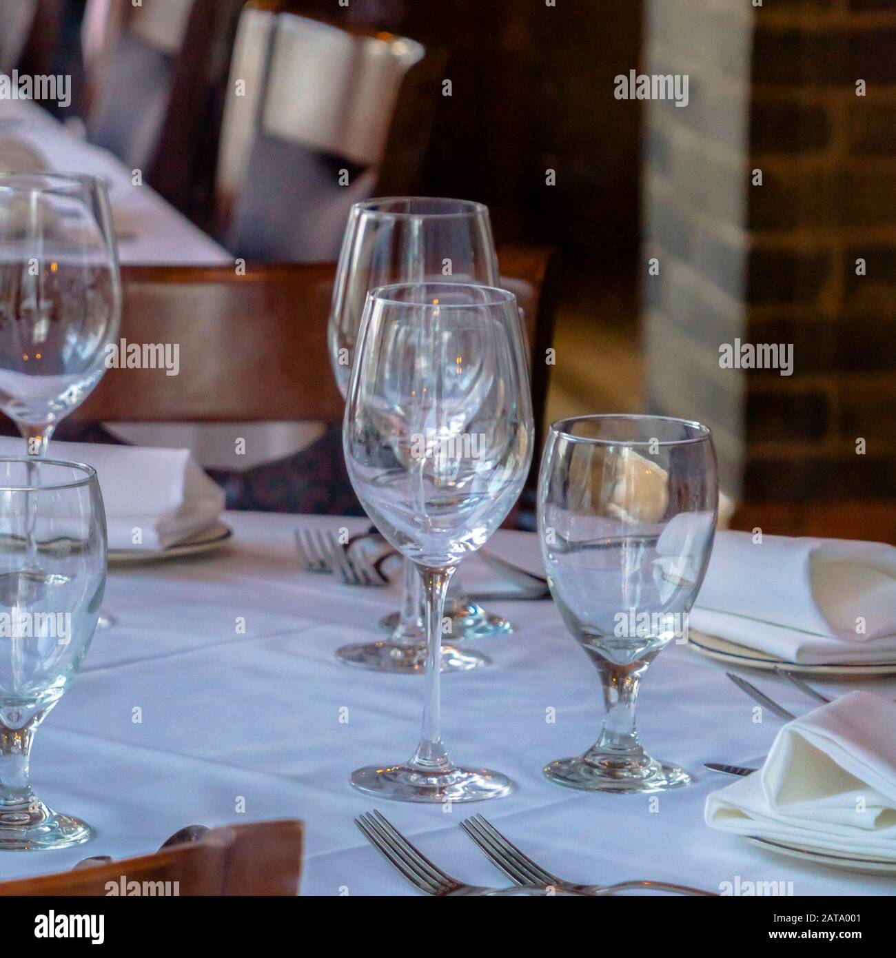 Vaisselle carrée sur table ronde avec un tissu blanc pour manger à l' occasion Photo Stock - Alamy