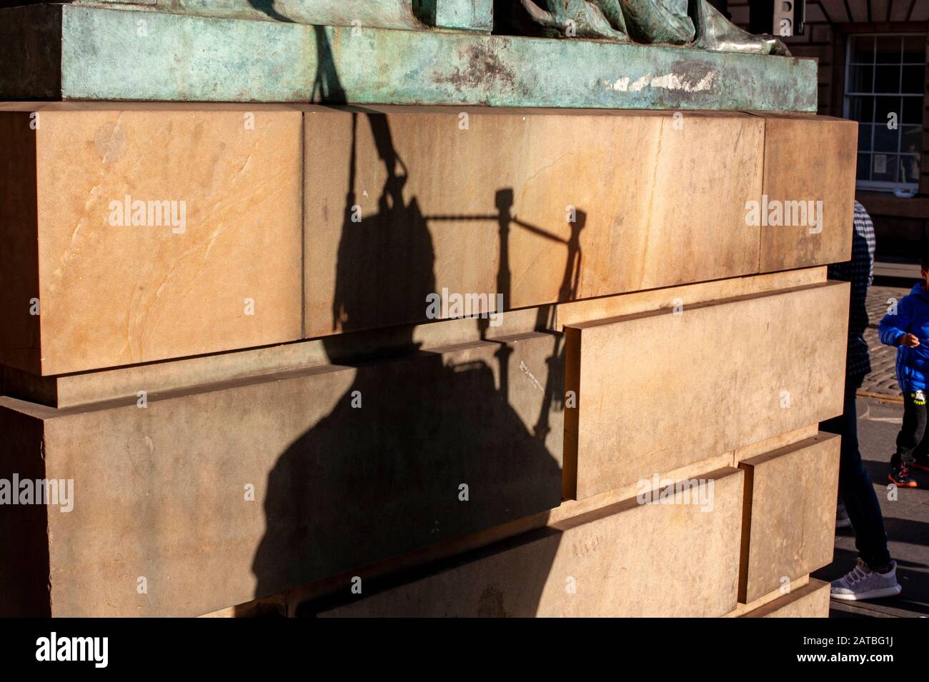 Silhouette de cornemuse écossaise contre un mur dans le Royal Mile à Édimbourg. Photographie de voyage/paysage urbain d'Édimbourg par Pep Masip. Banque D'Images