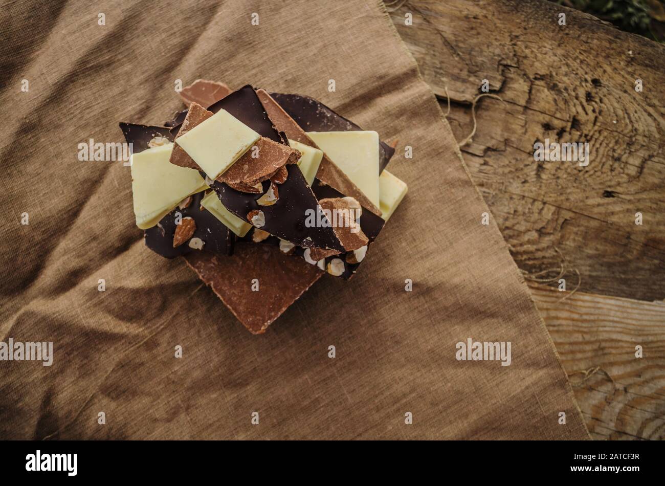 Barres de chocolat noir, lait et blanc sur fond de bois. De nombreux types de chocolat Banque D'Images