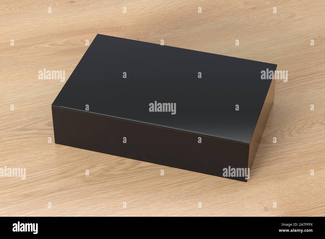 Boîte plate large noire vierge avec couvercle rabattable fermé sur fond en bois. Chemin de détourage autour de la maquette de boîte Banque D'Images