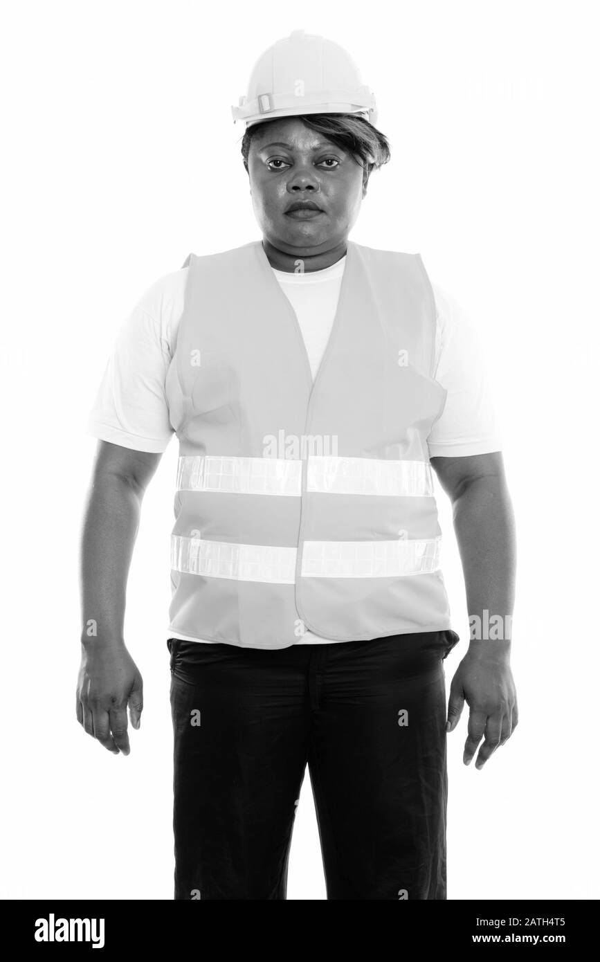 Studio tourné de graisse noire africaine femme travailleur de la construction debout Banque D'Images