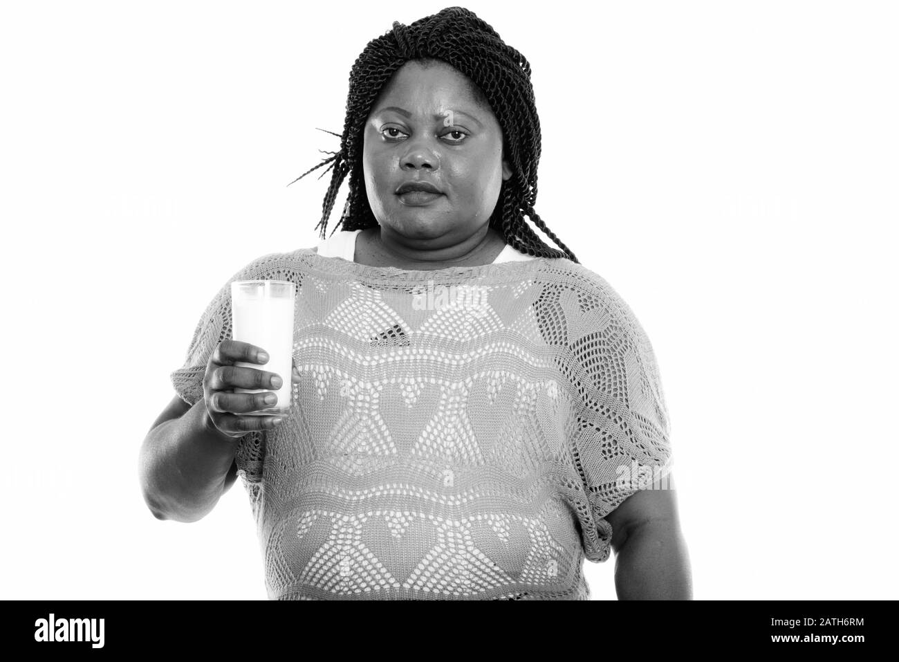 Studio shot of fat black African woman holding verre de lait Banque D'Images
