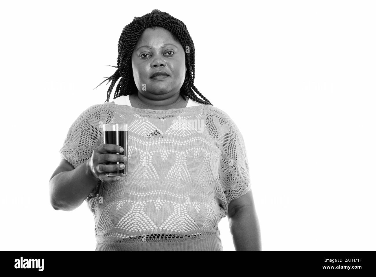 Studio tourné de graisse noire africaine femme tenant un verre de boisson soda Banque D'Images