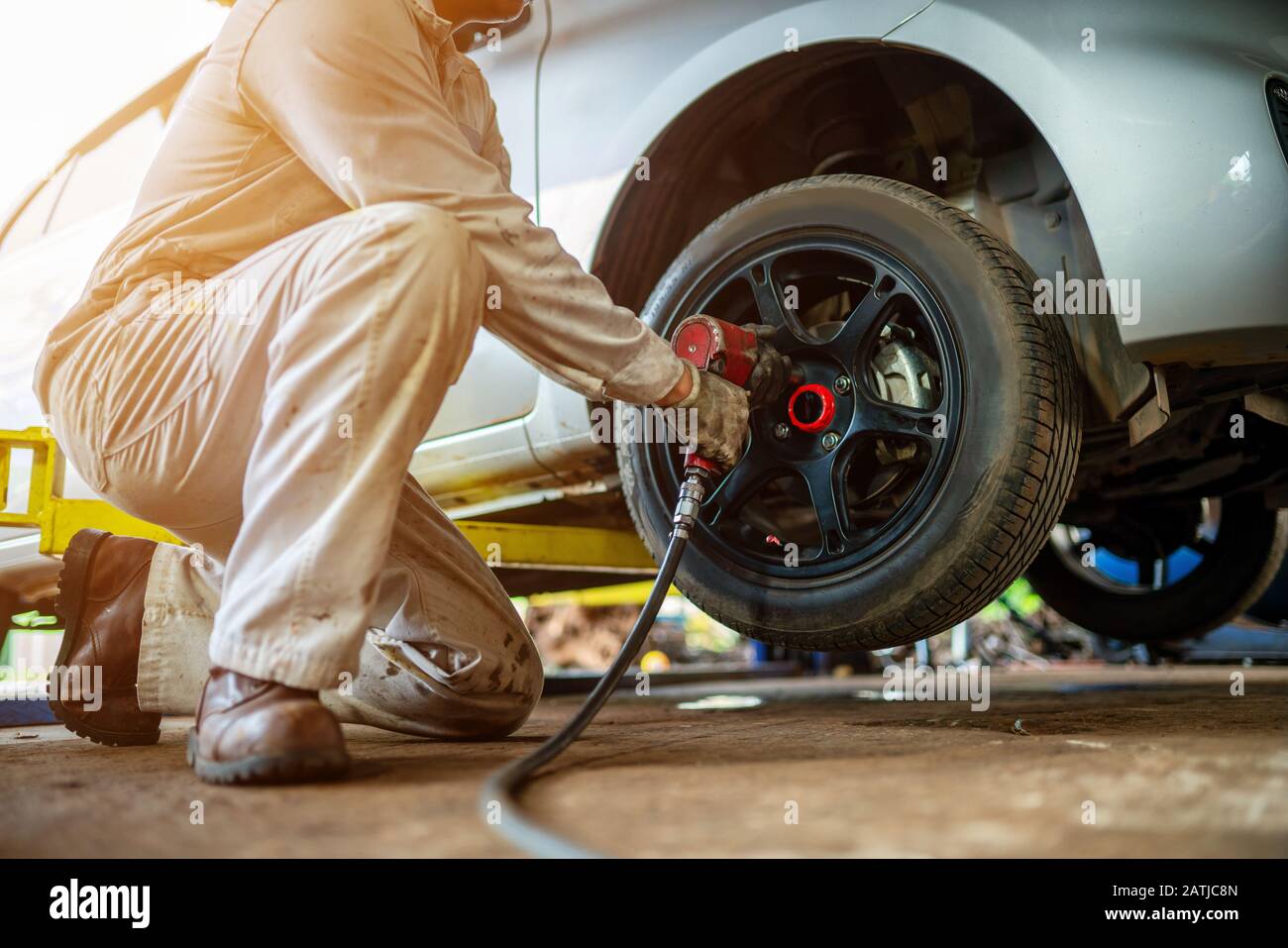 Les techniciens automobiles réparent les pneus ou décollent les roues. Banque D'Images