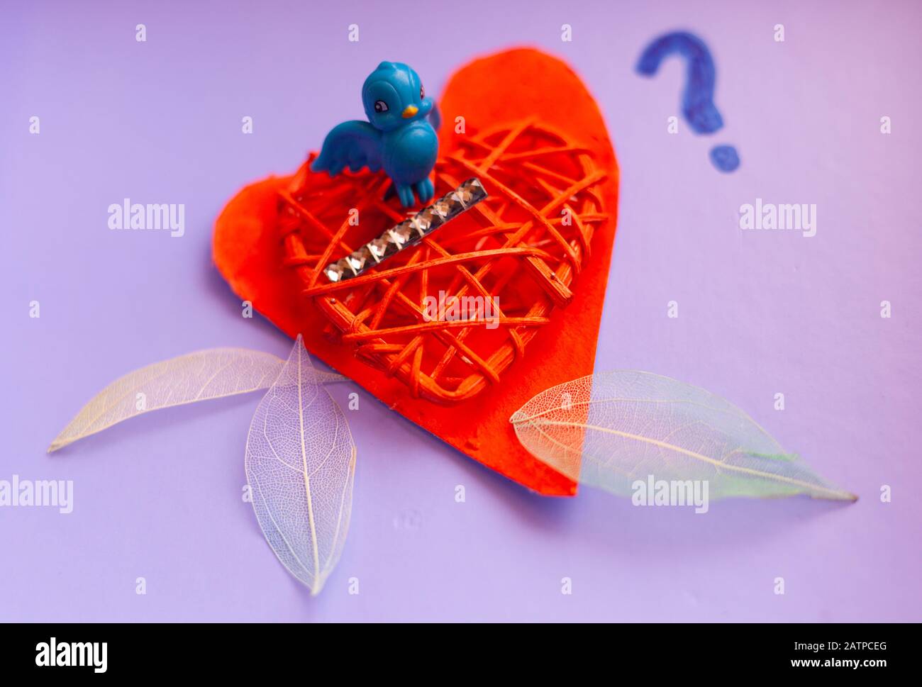 Toujours la vie, l'amour et le romantisme léger concept - petit oiseau bleu  imbriqué sur des coeurs rouges peints avec des plumes de tissu autour de  bordure. Copyspace Photo Stock - Alamy