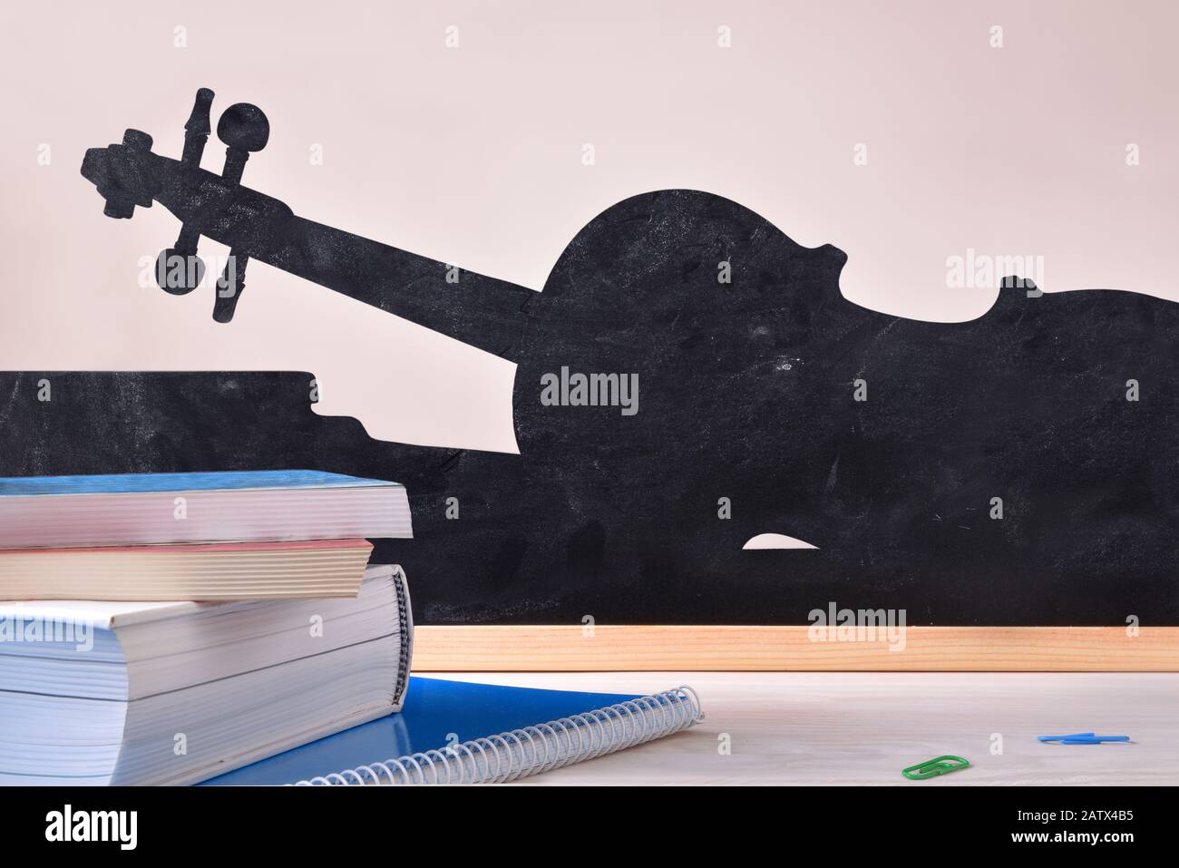 Concept de cours de musique avec livres sur la table et silhouette de violon sur le fond. Vue de face. Composition horizontale. Banque D'Images
