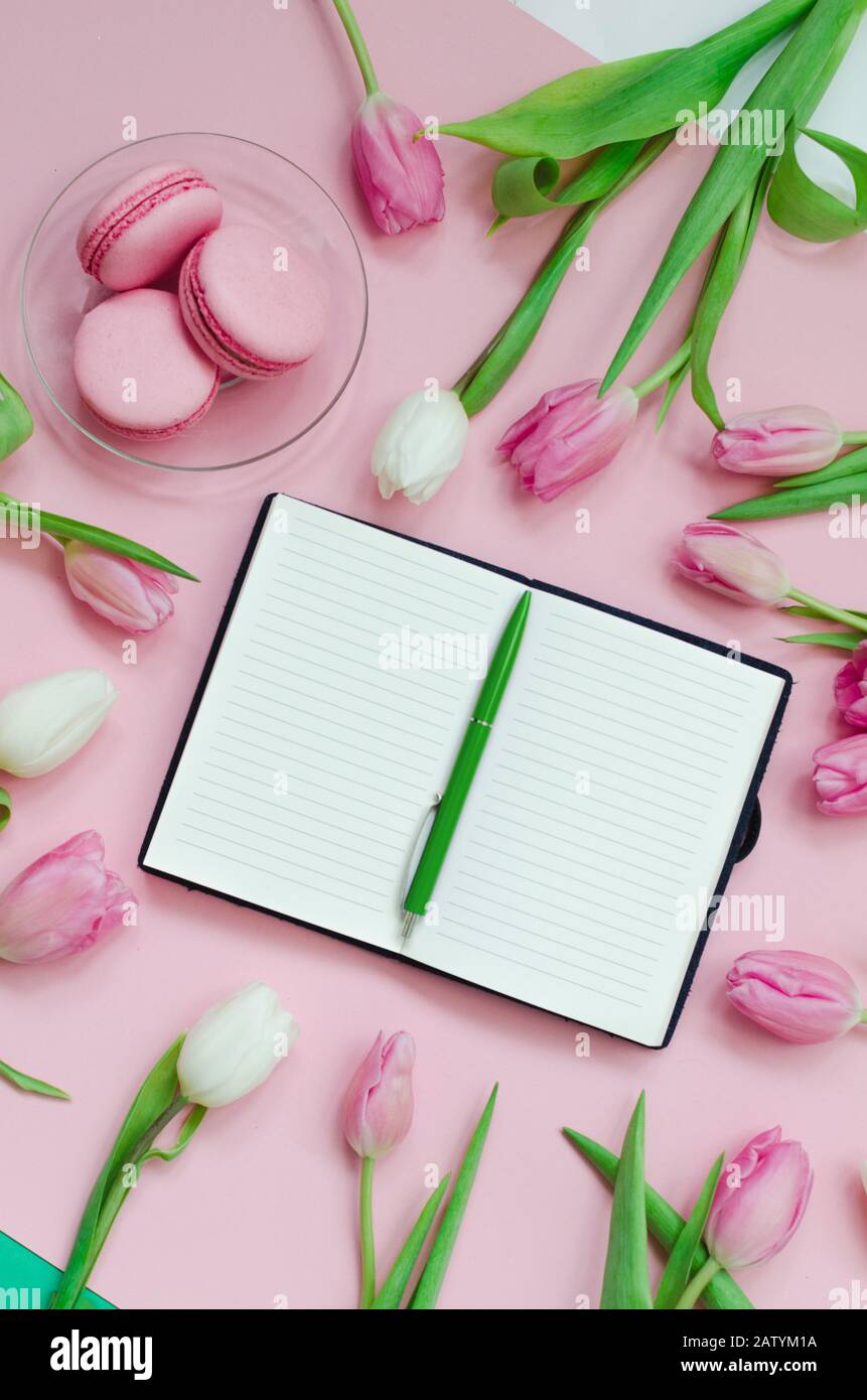 Bloc-notes avec liste de souhaits pour les plans futurs. Composition plat avec fleurs, bloc-notes, une tasse de café et des bonbons Banque D'Images