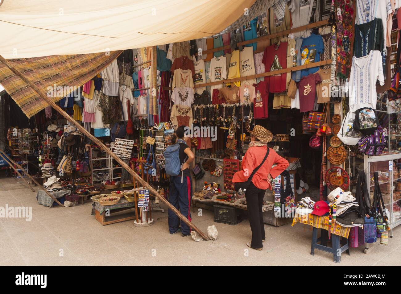 Guatemala, Parc national de Tikal, Centre d'accueil, vendeur de souvenirs et touriste de femme près de l'entrée du site de Tikal; site du patrimoine mondial de l'UNESCO Banque D'Images