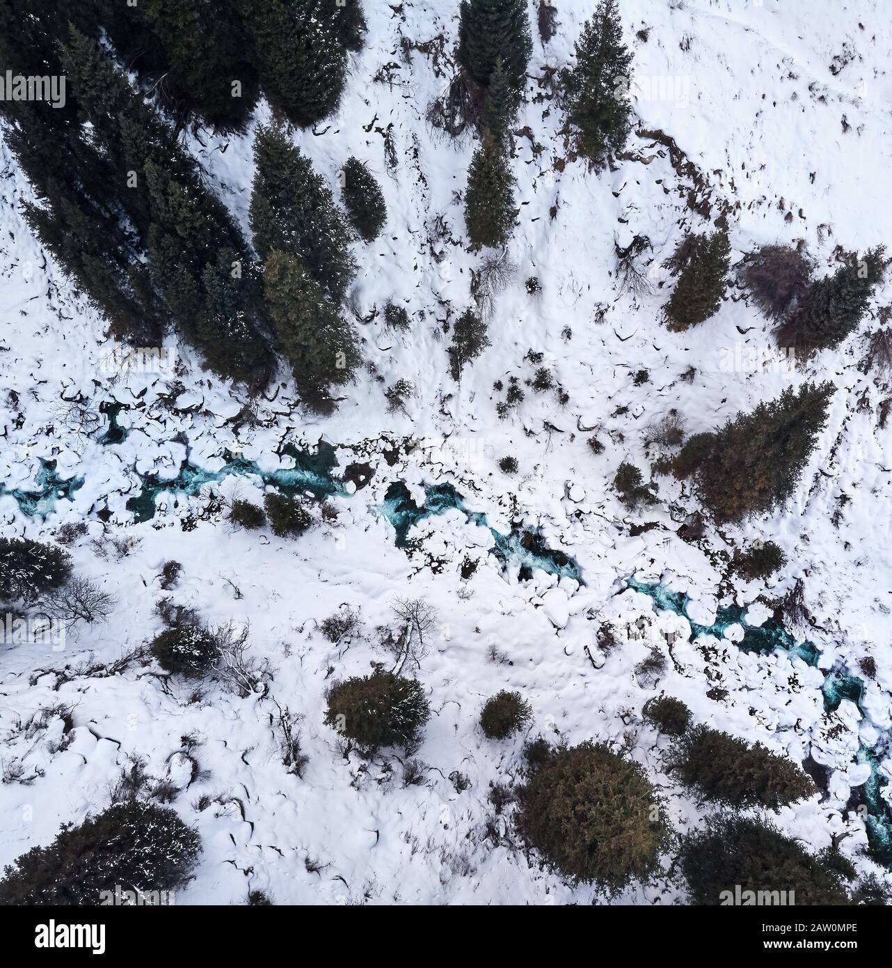 Vue aérienne de la rivière dans la forêt en hiver dans les montagnes. Tir drone, vue de dessus. Banque D'Images