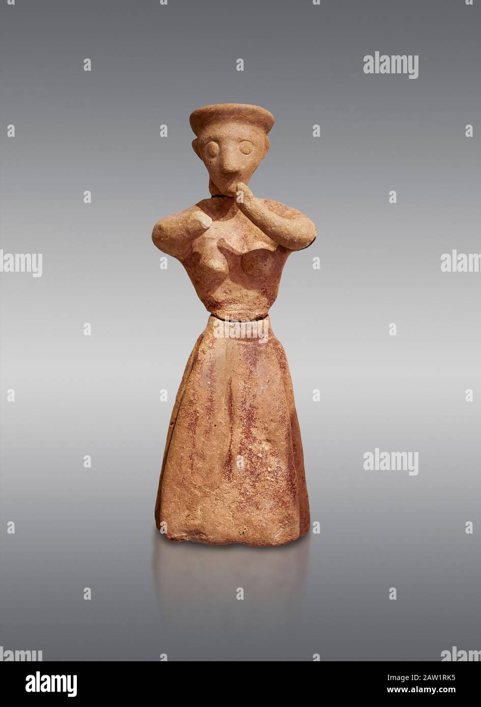 Figurine femelle en argile de Minoan dans l'attitude de culte, Chamezi 1900-1700 av. J.-C.; Musée archéologique d'Héraklion, fond gris. Banque D'Images