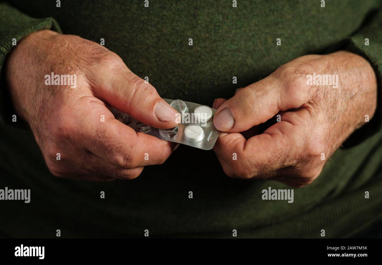 Homme âgé prenant un comprimé d'un blister Banque D'Images