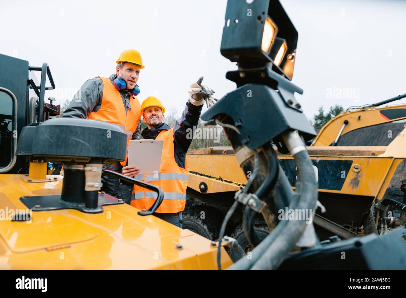 Deux hommes travaillant sur la pelle hydraulique pour l'excavation ou la carrière Banque D'Images