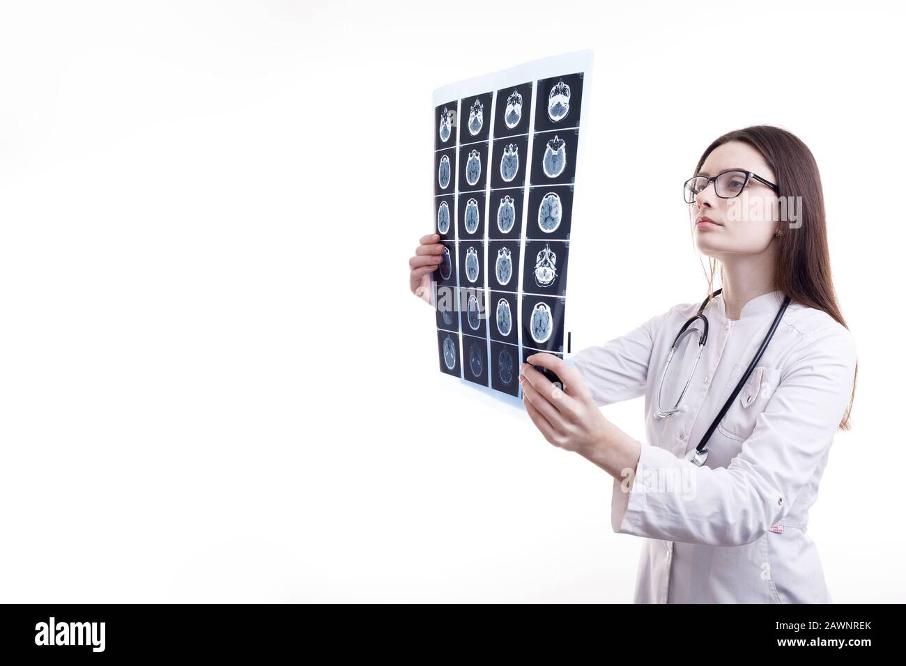 Femme Brunette Doctor En Regardant le film radiographique de tomodensitométrie Banque D'Images