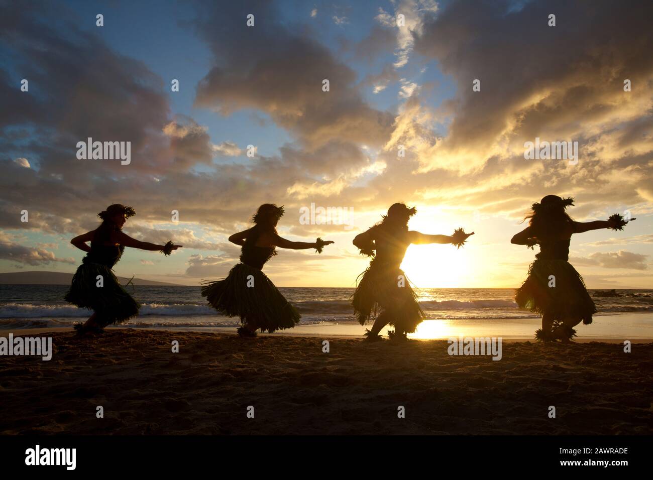 Quatre danseurs hula au coucher du soleil à Palauea, Maui, Hawaï. Banque D'Images