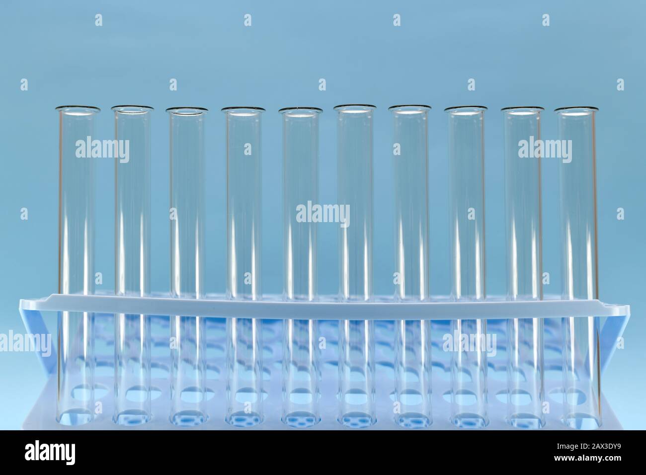 Plateau bleu avec une lumière transparente des tuyaux et des cols à l'ombre sur un fond bleu. Banque D'Images