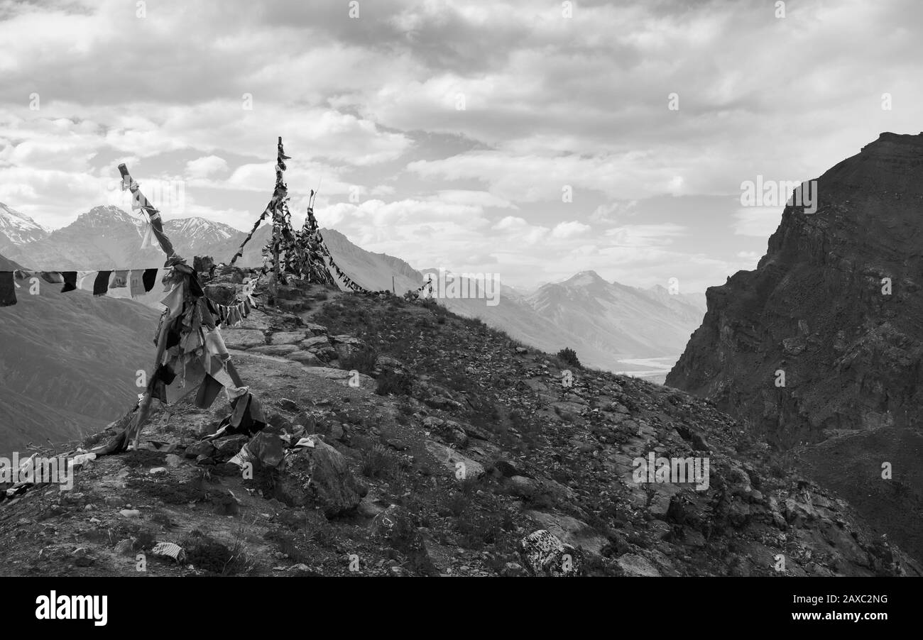 Un aperçu de la rivière Spiti et de la vallée et des pics de l'Himalaya et des drapeaux de prière sur une journée d'été surcouchée près de Kaza, Himachal Pradesh, Inde. Banque D'Images