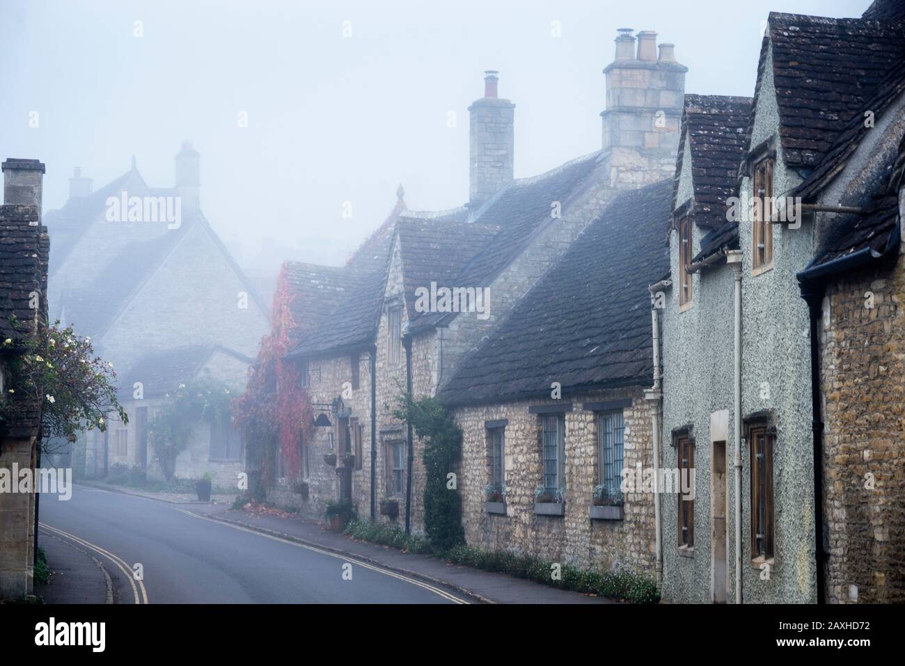 Des lignes de toit variées de bâtiments en pierre anglaise sont présentées dans le brouillard du matin. Banque D'Images