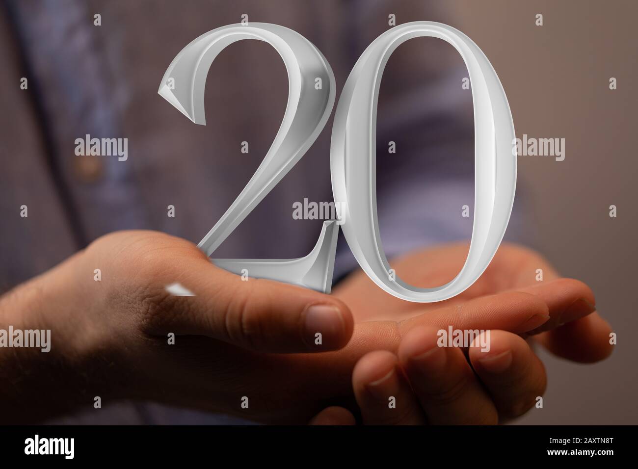 Illustration du numéro 20 au-dessus des mains de quelqu'un Banque D'Images