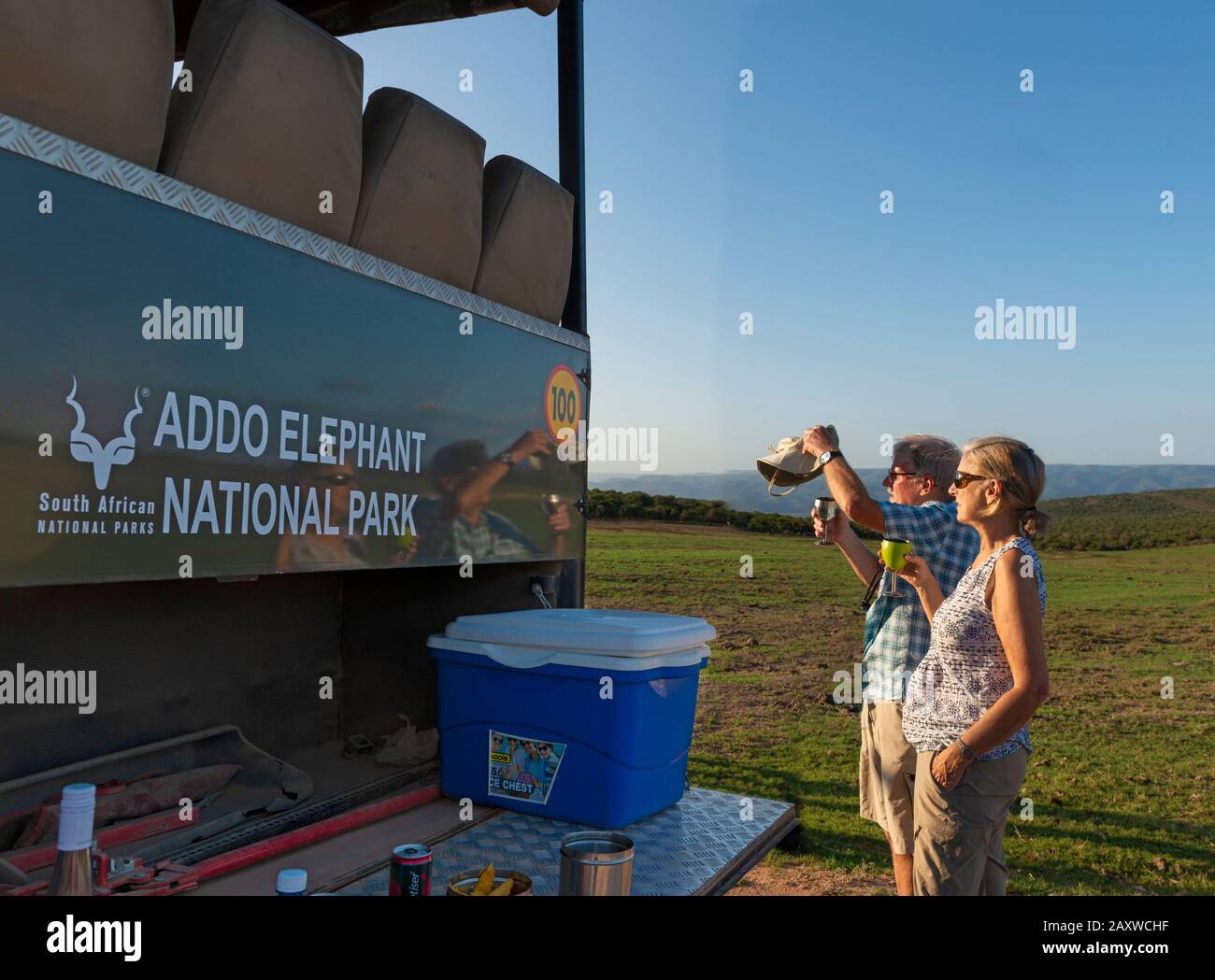 Les touristes à la recherche de la faune et à prendre un verre lors d'une promenade de jeu en soirée dans le parc national Addo Elephant, le Cap oriental, Afrique du Sud Banque D'Images