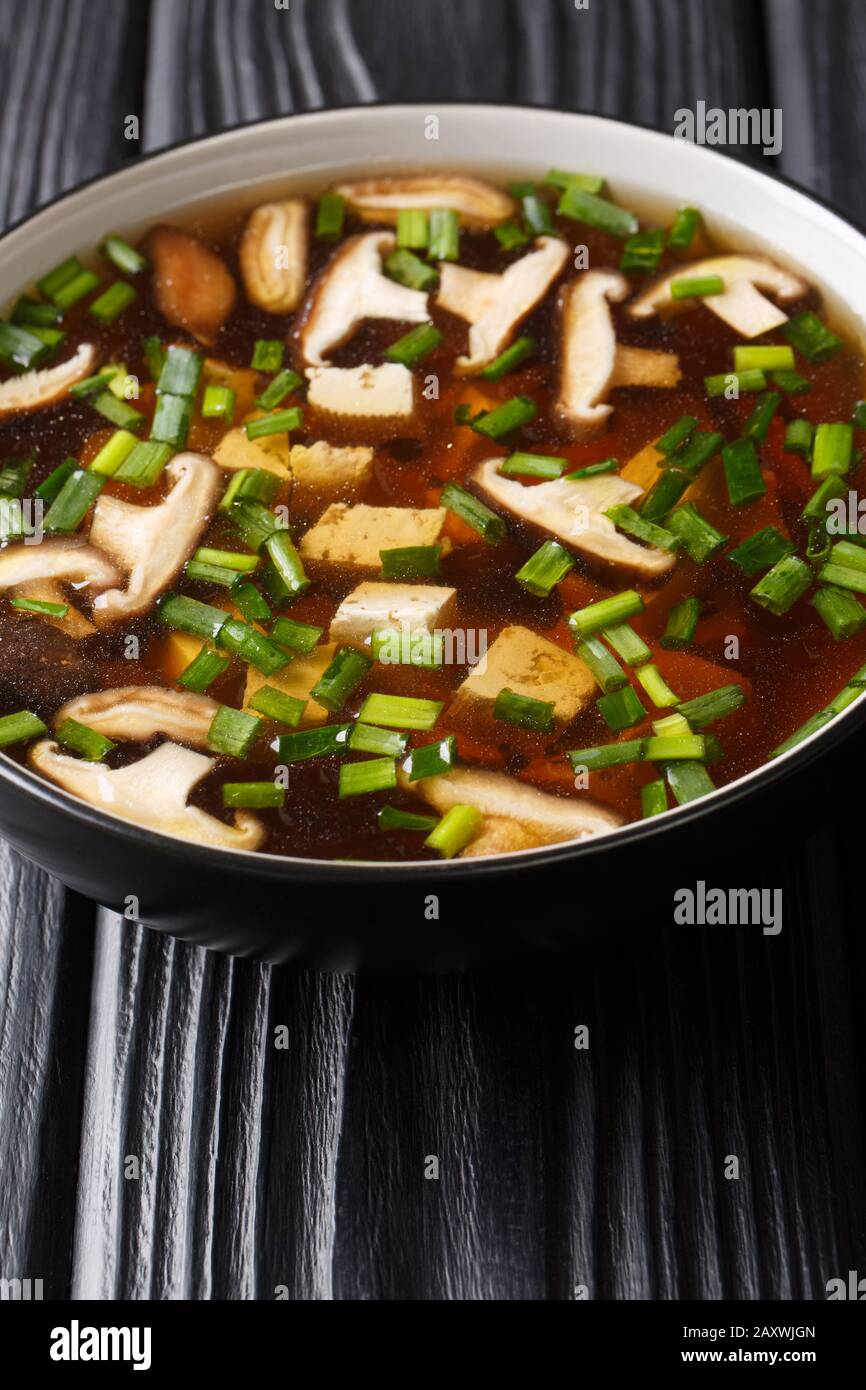 Soupe de miso végétarienne aux champignons shiitake, tofu et oignons verts dans un bol sur la table. Verticale Banque D'Images