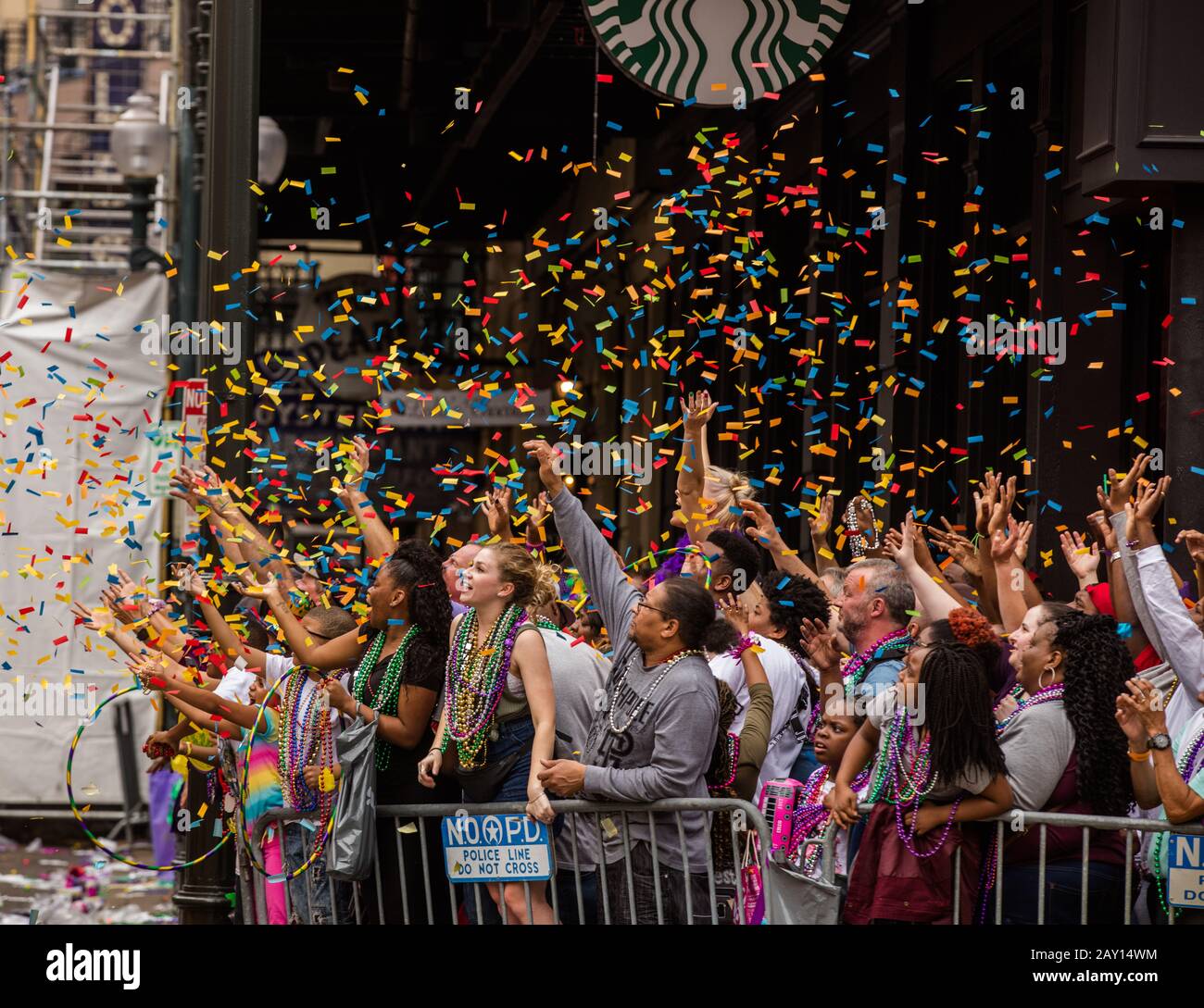 Mardis gras spectateurs/célébrateurs qui ont accès à des goodies, y compris des confettis, des perles, des hula et d'autres jouets mis en avant par un float de Krewe Iris. Banque D'Images