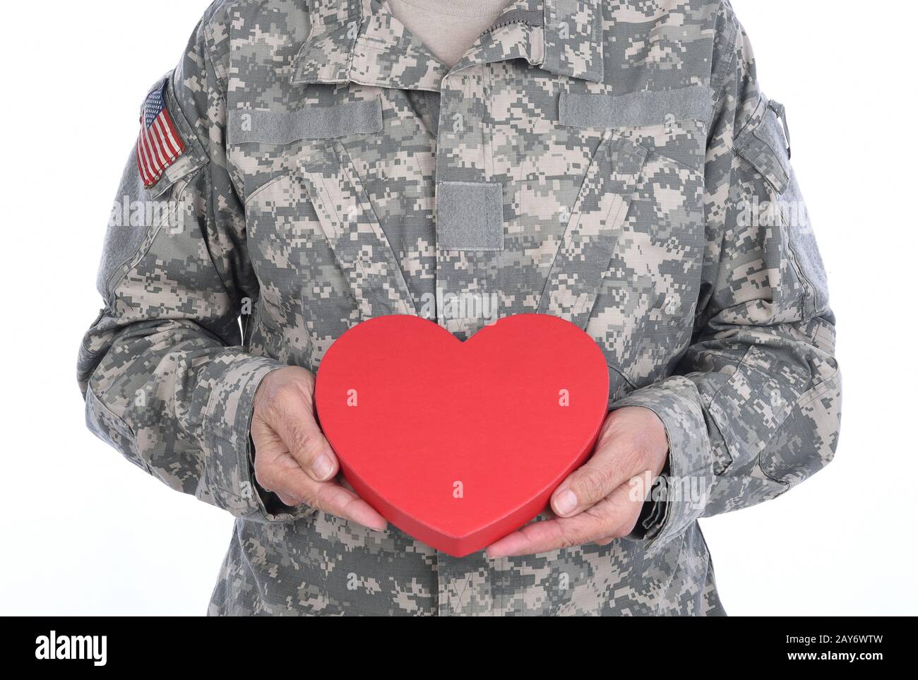 Gros plan d'un soldat tenant une boîte de bonbons rouge en Forme de coeur de la Saint Valentin. Banque D'Images