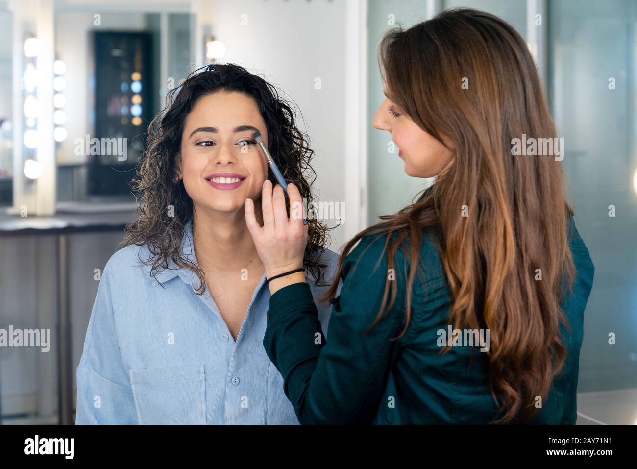Professionnel maquillage artiste faire le maquillage à une belle jeune  fille dans l'étude mignonne Photo Stock - Alamy
