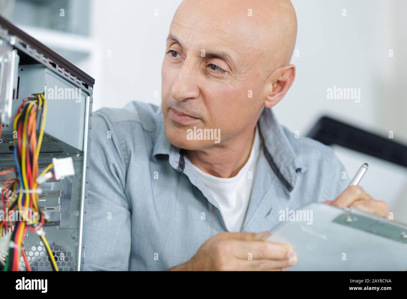 un technicien mâle fixe les câbles pc Banque D'Images