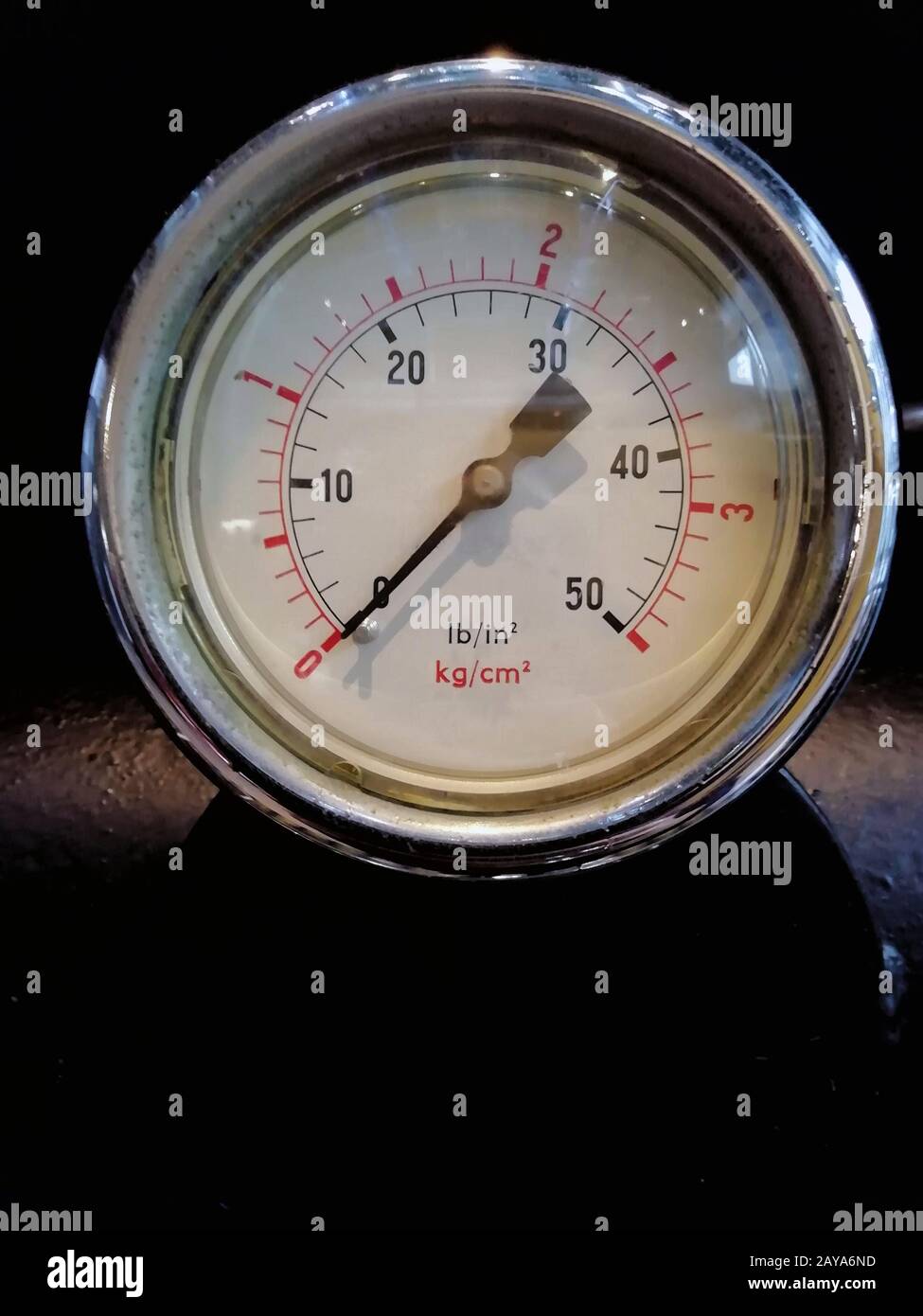 manomètre rond avec numéros marqués en psi et métrique sur le cadran du compteur sur les machines industrielles Banque D'Images