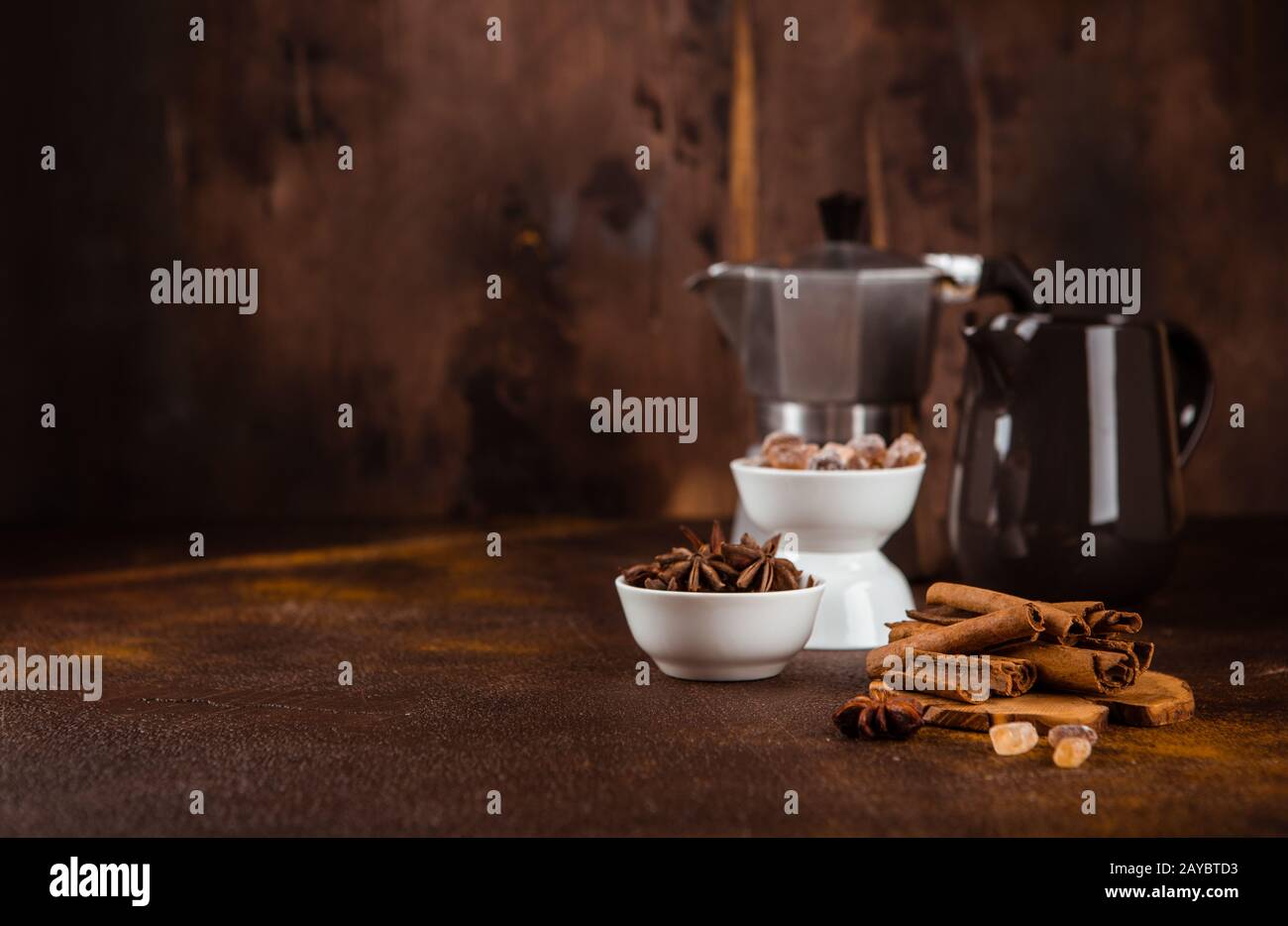 Cafetière avec épices sur fond brun. Banque D'Images