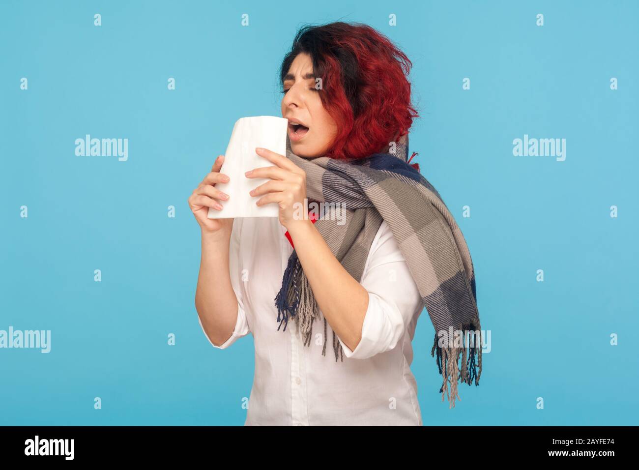 Épidémie de grippe, épidémie de virus. Femme malade enveloppée d'une écharpe toussant, éternuant dans les tissus, souffrant de symptômes d'allergie ou de grippe, de maux de gorge et de fièvre Banque D'Images