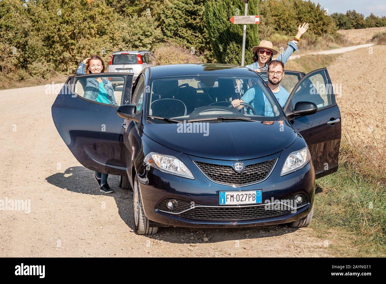 18 OCTOBRE 2018, TOSCANE, ITALIE: Heureux groupe d'amis se tenant près de la voiture. Voyage et vacances en Toscane et en Italie concept Banque D'Images