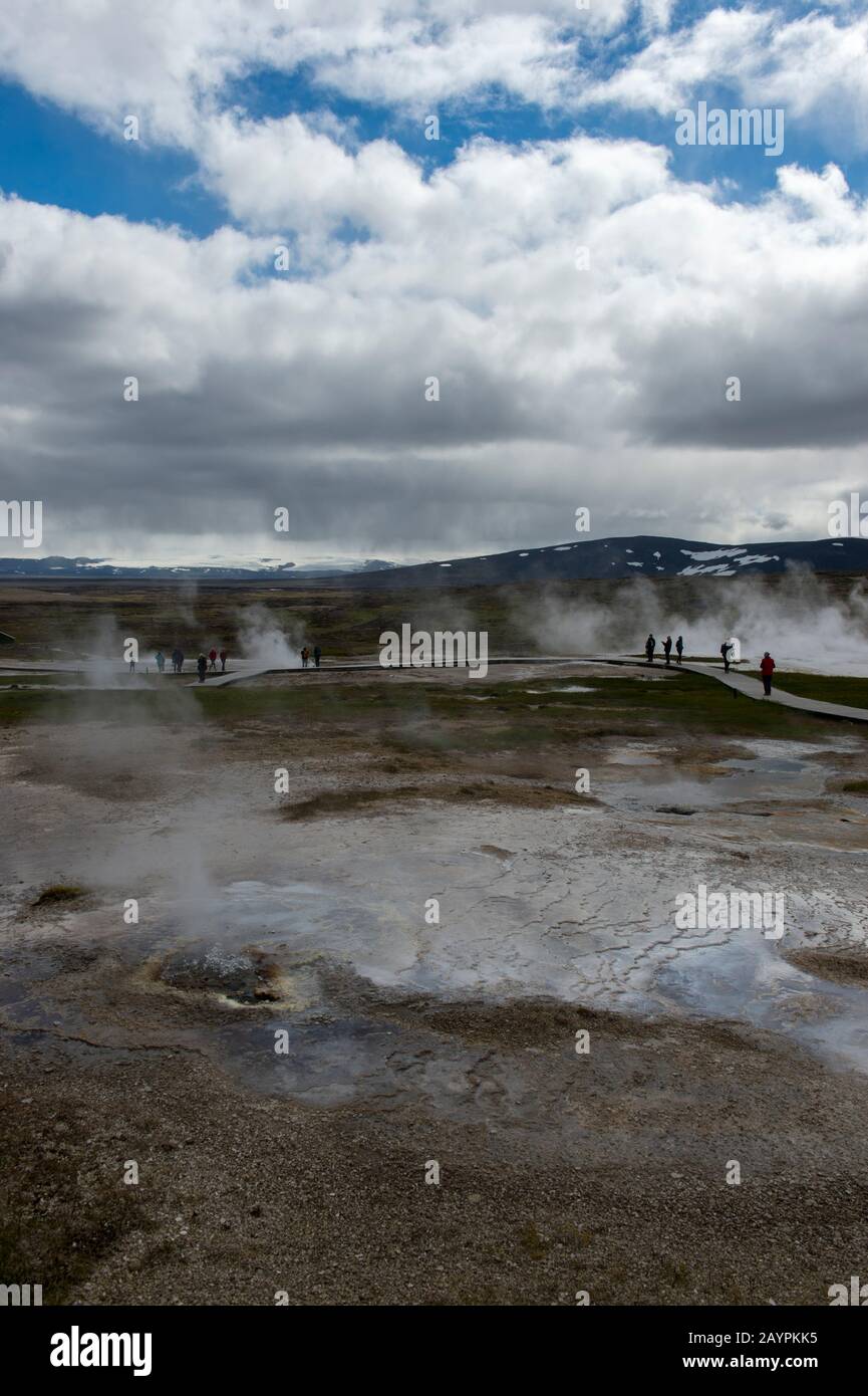 Les gens marchent sur les promenades à travers les sources chaudes à Hveravellir, une zone géothermique de fumarales, et des piscines chaudes multicolores dans le centre de l'aig Banque D'Images