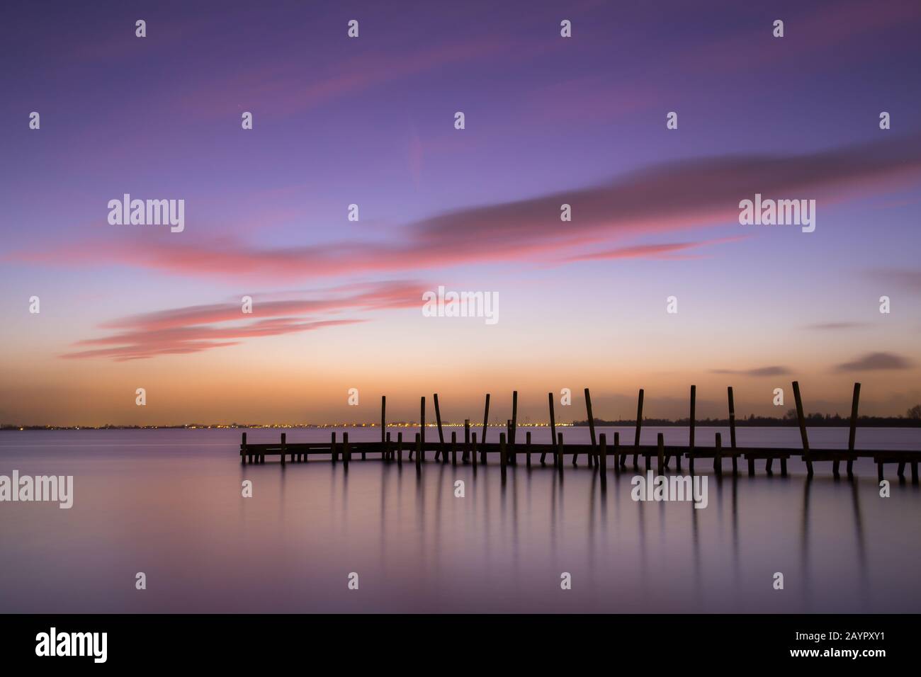 Magnifique coucher de soleil animé en hiver avec orange et violet à la jetée de Westeinderplassen à Aalsmeer près d'Amsterdam, aux Pays-Bas. Banque D'Images