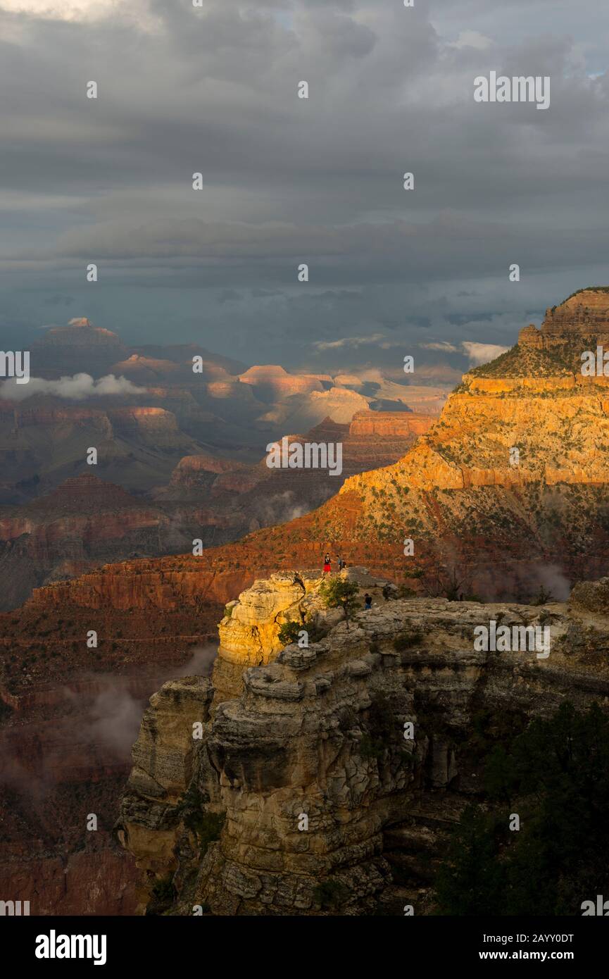 Les gens sur une affleurement rocheux entre Yavapai point et Mather point sur le plateau sud du Grand Canyon avec des nuages défrichement après un orage dans le Banque D'Images