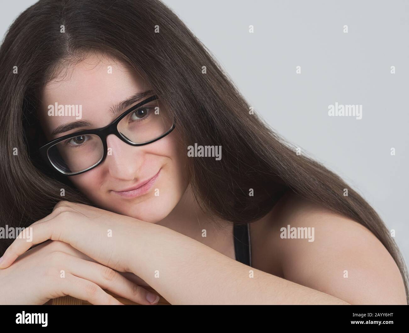 Portrait d'une fille de Brunette Teen à poil long espectacacled Smiling Banque D'Images