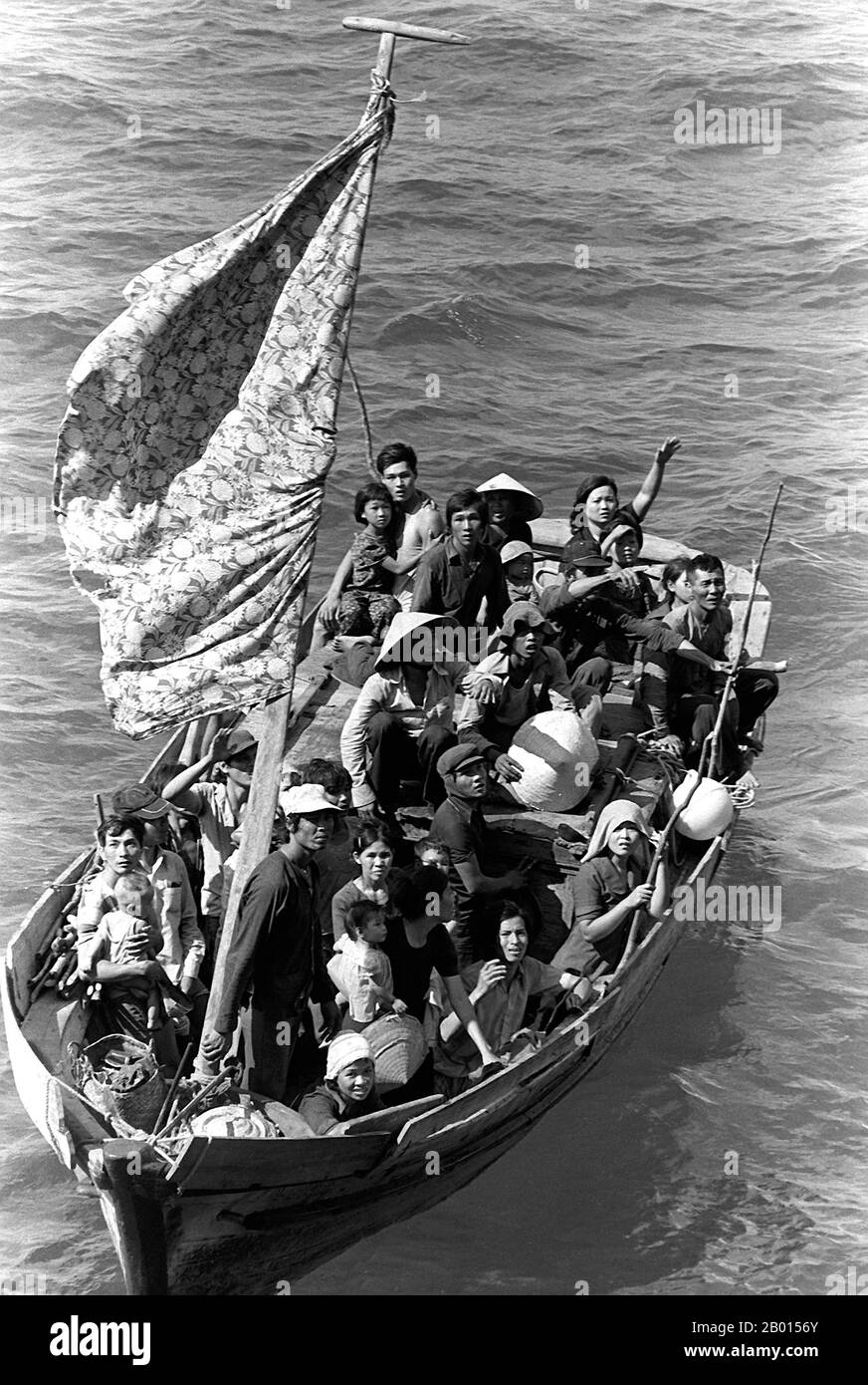 Vietnam: Un groupe de "boat People" vietnamiens sont sauvés en mer, 15 mai 1984. Photo de Phil Eggman. 35 réfugiés vietnamiens attendent d'être pris à bord du navire de commandement amphibie USS Blue Ridge. Ils sont sauvés d'un bateau de pêche à 350 miles au nord-est de Cam Ranh Bay, Vietnam, après avoir passé huit jours en mer. Les gens de bateau est un terme qui se réfère habituellement aux réfugiés ou aux demandeurs d'asile qui égrent en nombre dans des bateaux qui sont parfois vieux et grossièrement fabriqués. Ce terme est entré en usage courant à la fin des années 1970 avec le départ massif des réfugiés vietnamiens du Vietnam contrôlé par les communistes. Banque D'Images