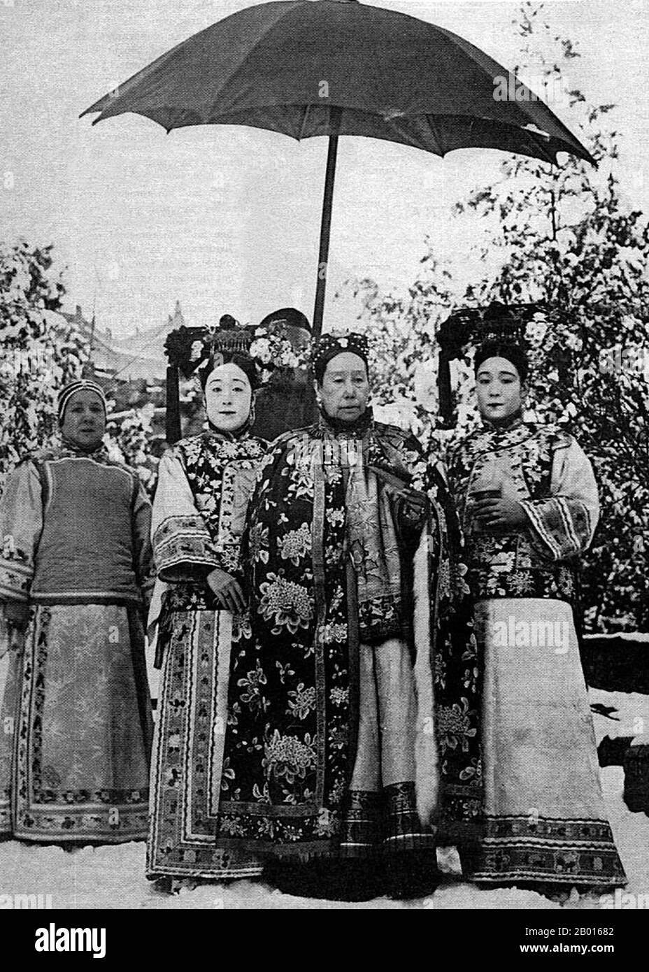 Chine : impératrice Dowager Cixi (29 novembre 1835 - 15 novembre 1908) avec les préposés aux tribunaux c.1905. L'impératrice Dowager Cixi, nom personnel Xingzhen, était la concubine de l'empereur Xianfeng.Du Manchu Yehe Nara Clan, elle était une figure puissante et charismatique qui devint le dirigeant de facto de la dynastie Qing pendant 47 ans, de 1861 à 1908.Son fils devint l'empereur Tongzhi, et elle régna comme régent à sa place, aux côtés de l'impératrice Dowager ci'an.Elle a consolidé son contrôle en installant son neveu comme empereur Guangxu après la mort de son fils.Son héritage est fortement débattu. Banque D'Images
