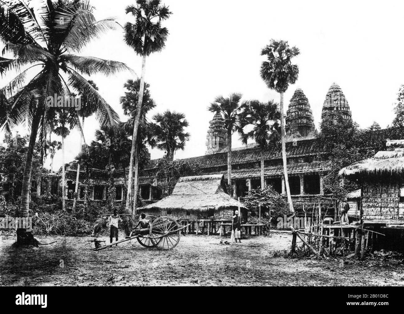 Cambodge: Palmiers à sucre, maisons à pilotis et une voiturette à Angkor Wat, 1909. Angkor Wat a été construit pour le roi Suryavarman II (r. 1113-1150) au début du 12th siècle comme son temple d'état et capitale. En tant que temple le mieux préservé du site d'Angkor, il est le seul à être resté un important centre religieux depuis sa fondation – d'abord hindou, dédié au dieu Vishnu, puis bouddhiste. C'est le plus grand bâtiment religieux au monde. Le temple est au sommet du style classique élevé de l'architecture khmère. Il est devenu un symbole du Cambodge, apparaissant sur son drapeau national. Banque D'Images